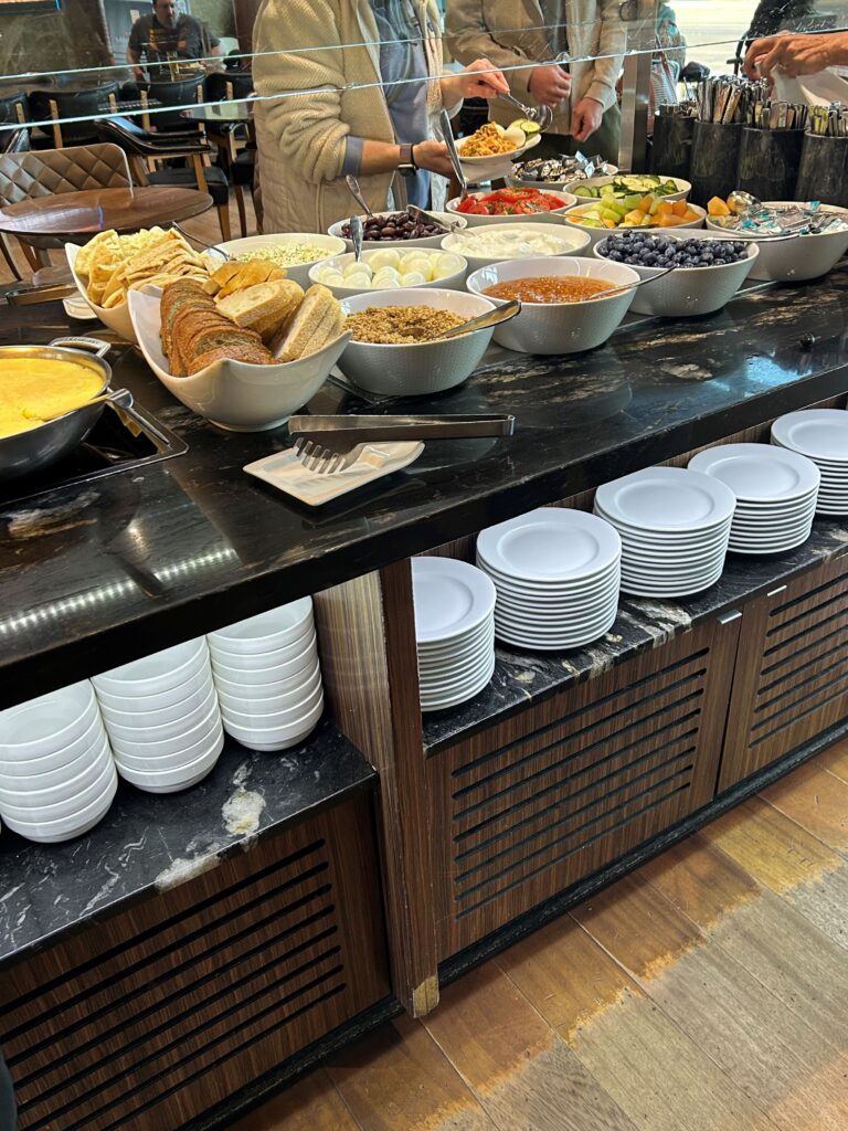 a buffet with plates and food on the counter