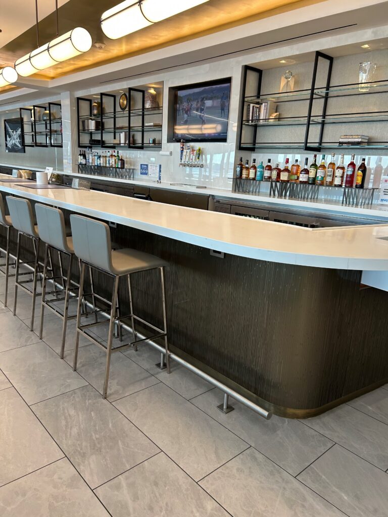 a bar with a row of bottles