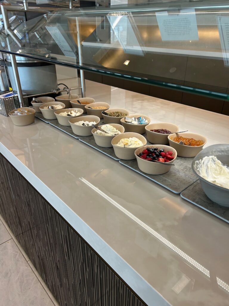 a row of bowls of food on a counter