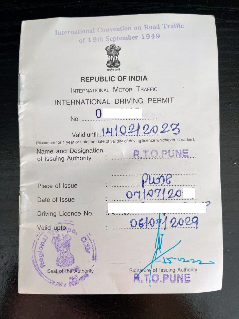 The image shows an International Driving Permit issued by the Republic of India. It includes details such as the permit number, validity date, place and date of issue, and the driving license number. There are official stamps and a signature from the issuing authority, R.T.O. Pune. The document references the International Convention on Road Traffic of 1949.