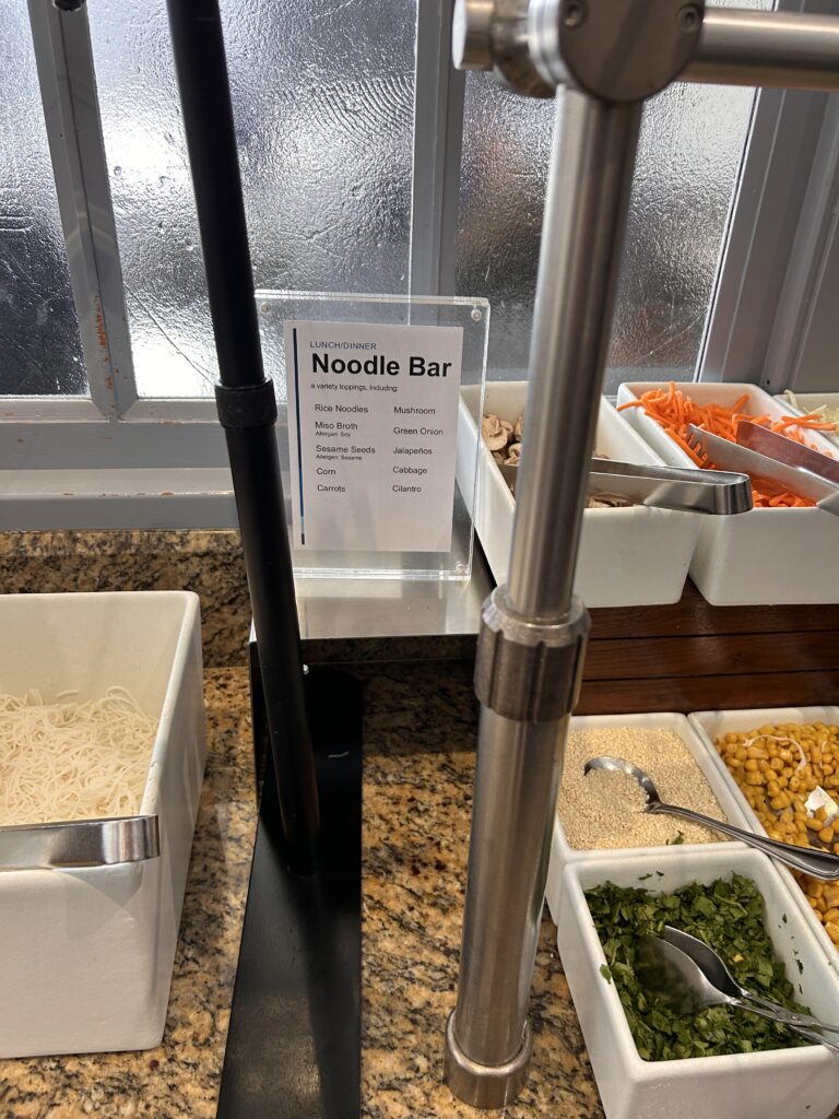 a noodle bar with a sign