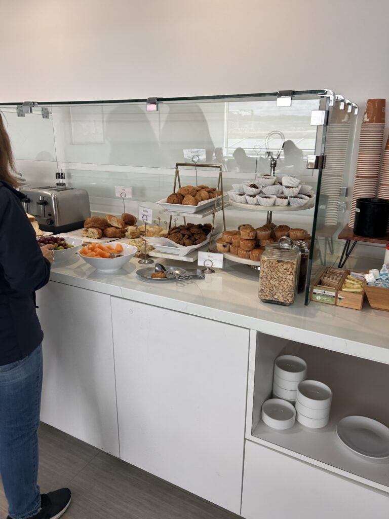 a woman standing in front of a counter with food