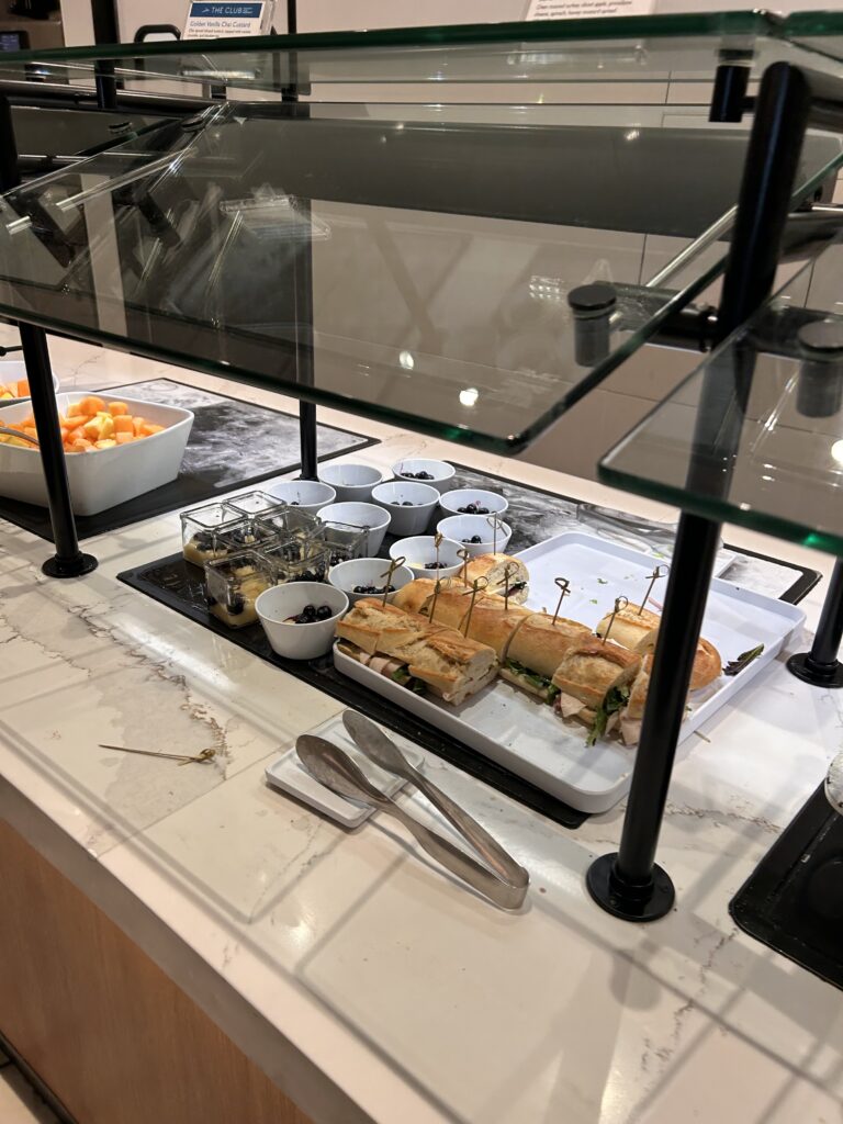 a tray of sandwiches and cups on a counter