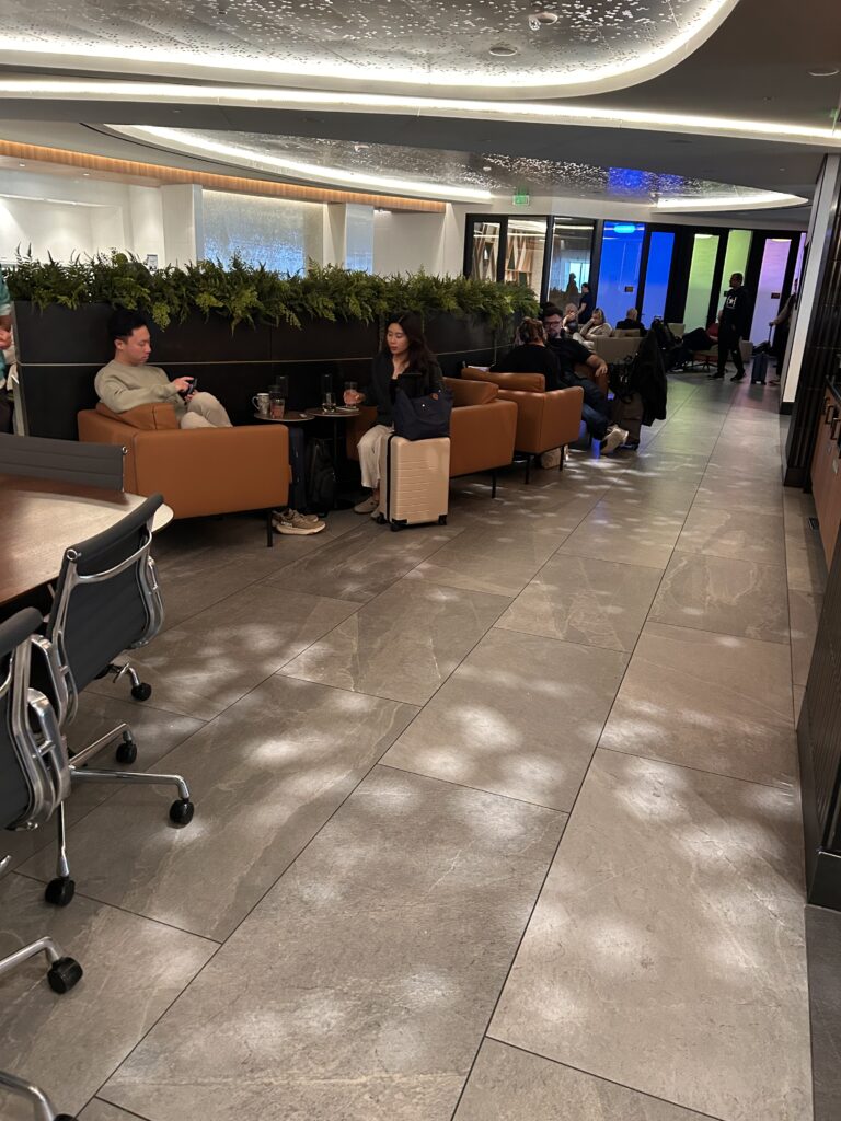 people sitting in a room with chairs and a couple of people