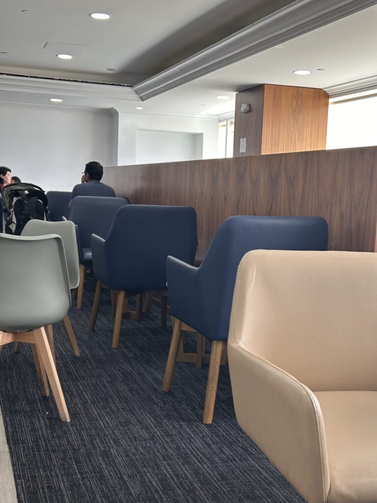a group of people sitting in a room with chairs