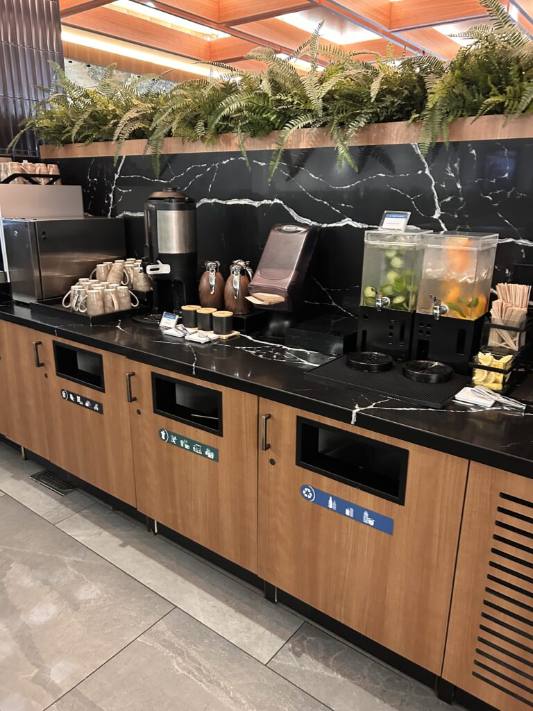 a counter with a variety of drinks and coffee machines