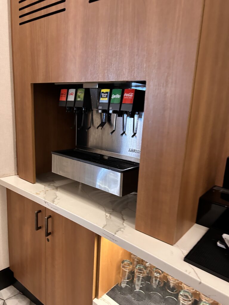 a beverage dispenser in a wood cabinet