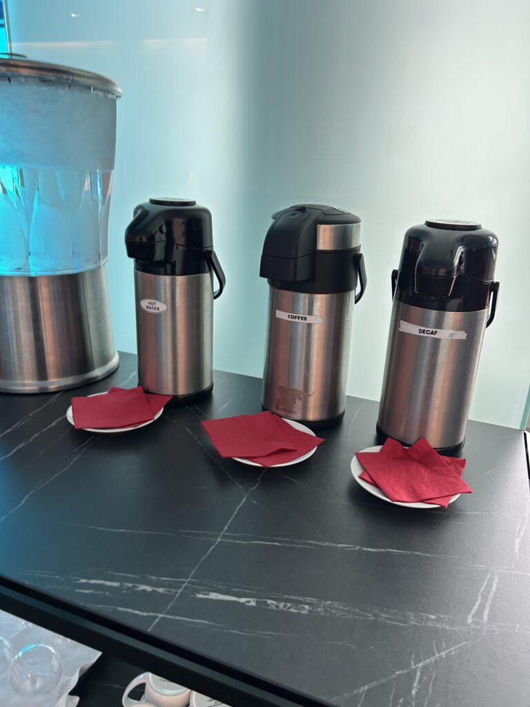 a group of metal containers with red napkins on plates