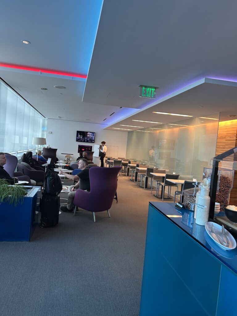 a room with a few people sitting in chairs