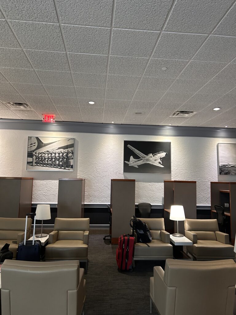 a room with chairs and luggage