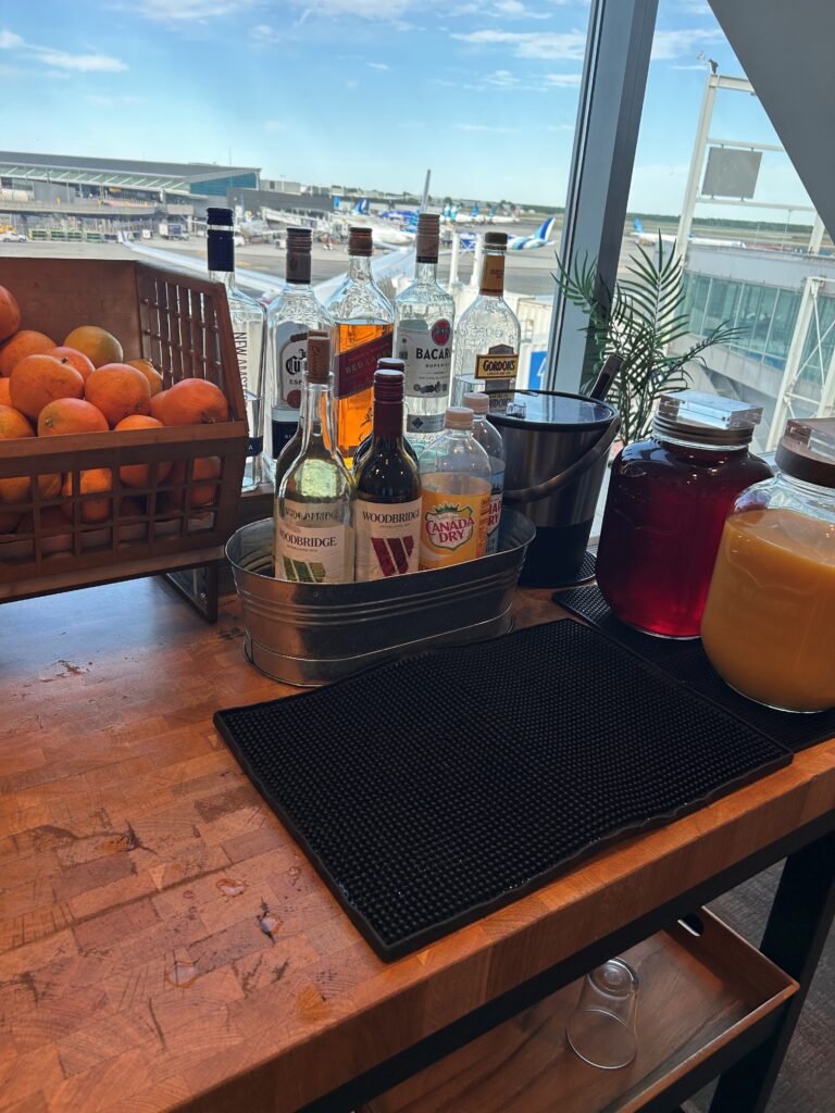a table with bottles of alcohol and fruit