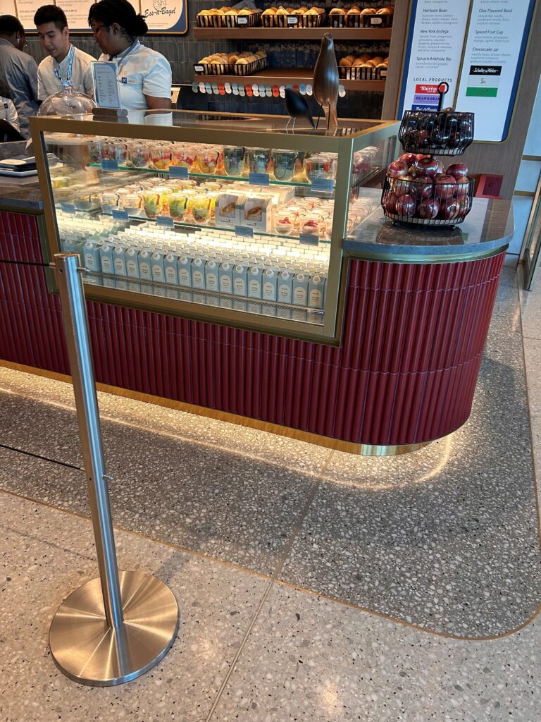 a counter with a glass case with drinks on it