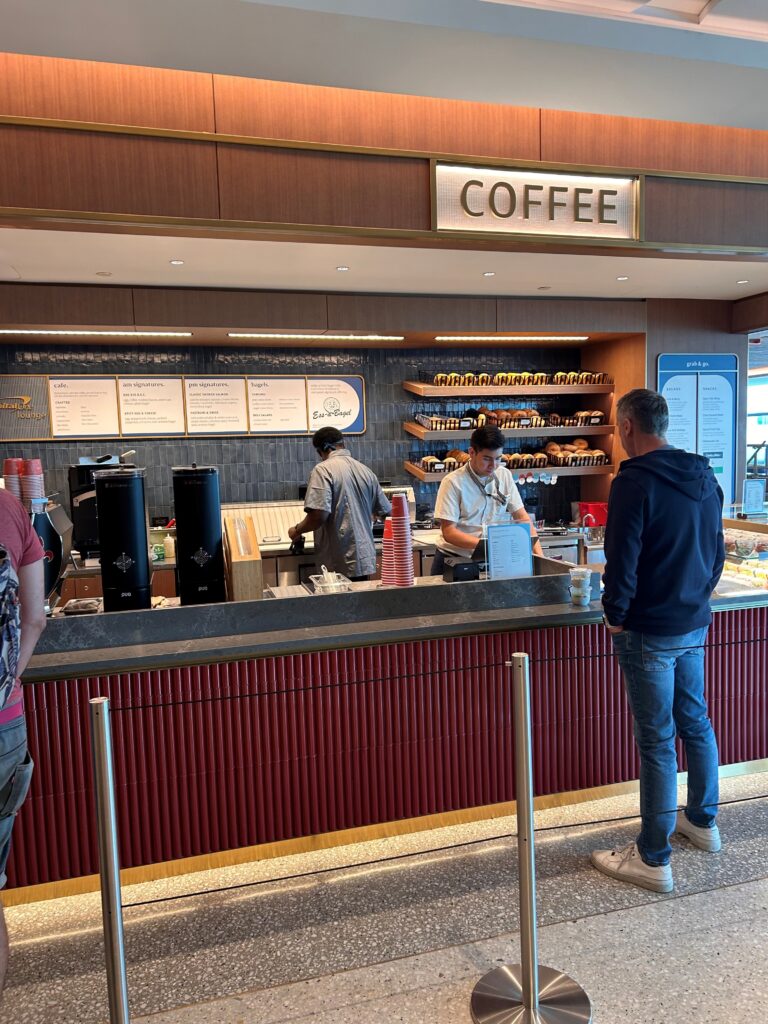 people standing in front of a coffee shop