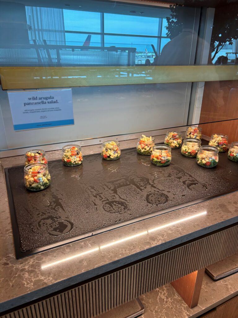 a group of jars of salad on a counter
