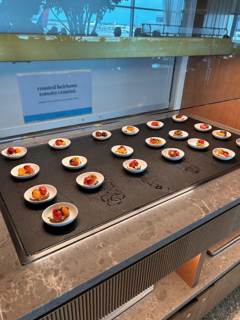 a group of small plates with food on a counter