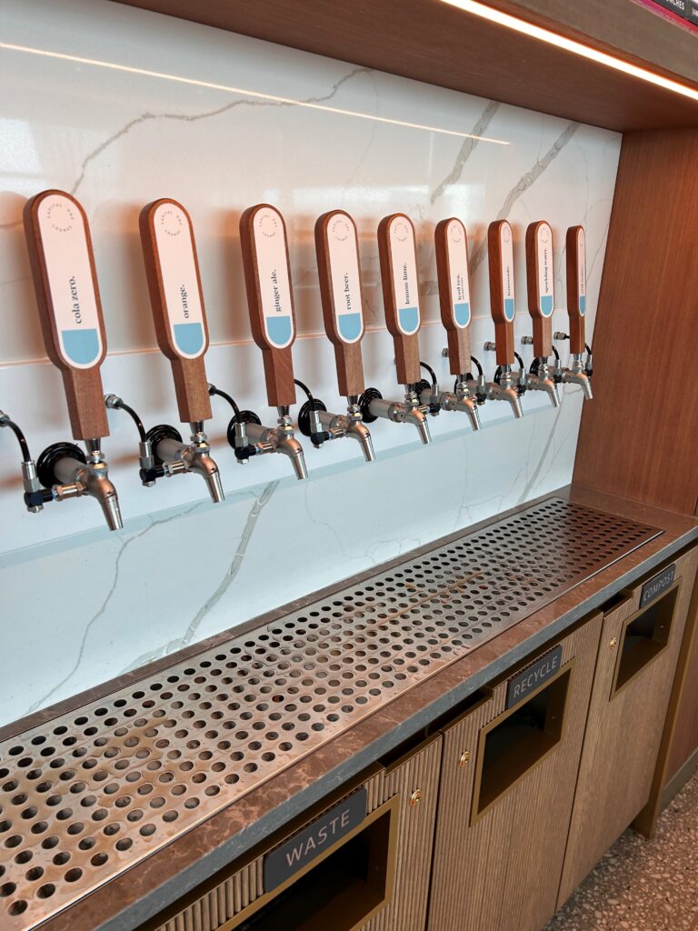 a row of beer taps on a wall