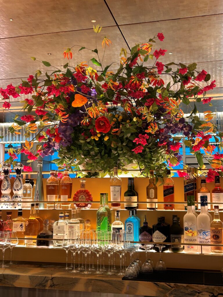 a bunch of flowers over a bar
