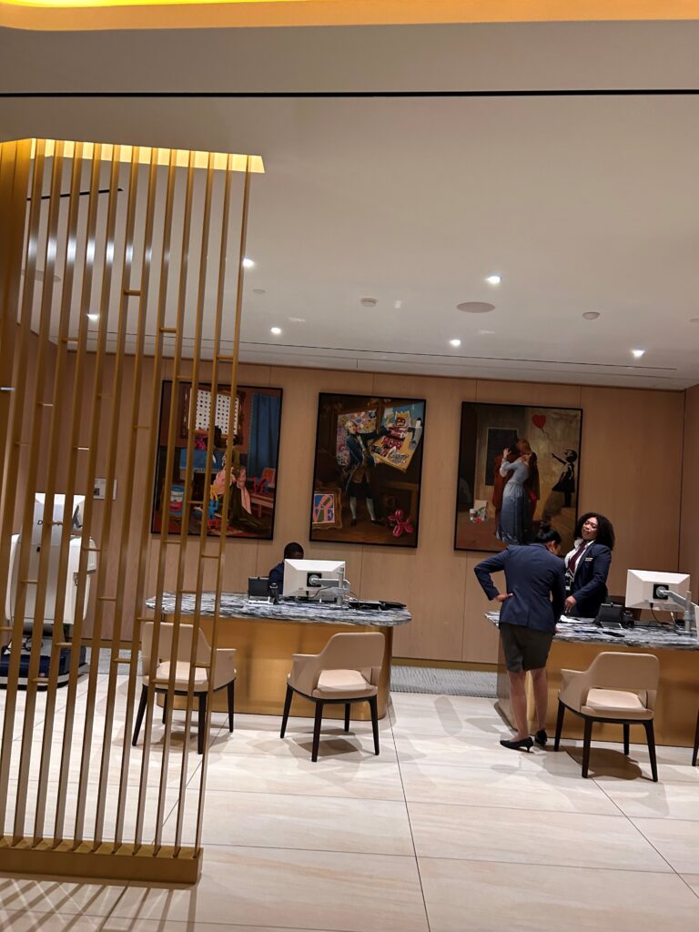 a group of people standing in a room with art on the wall