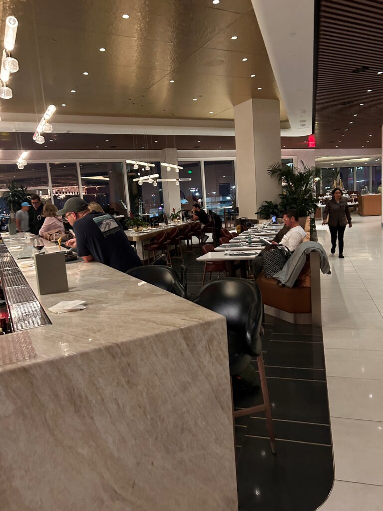 people sitting at tables in a restaurant