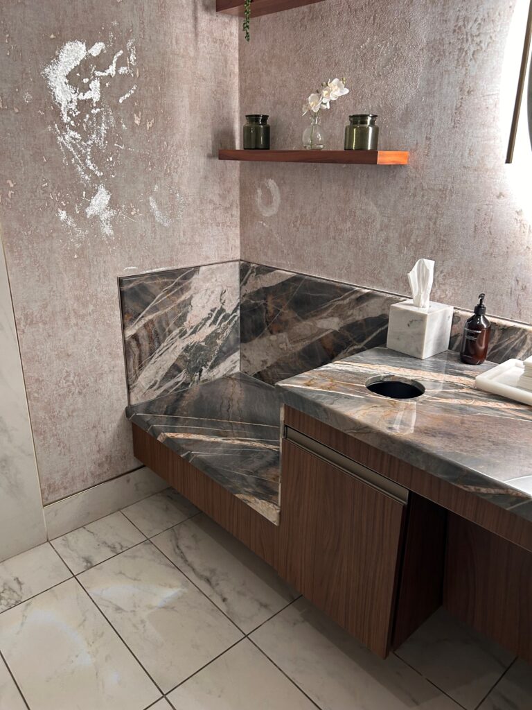 a bathroom with a marble countertop and a sink