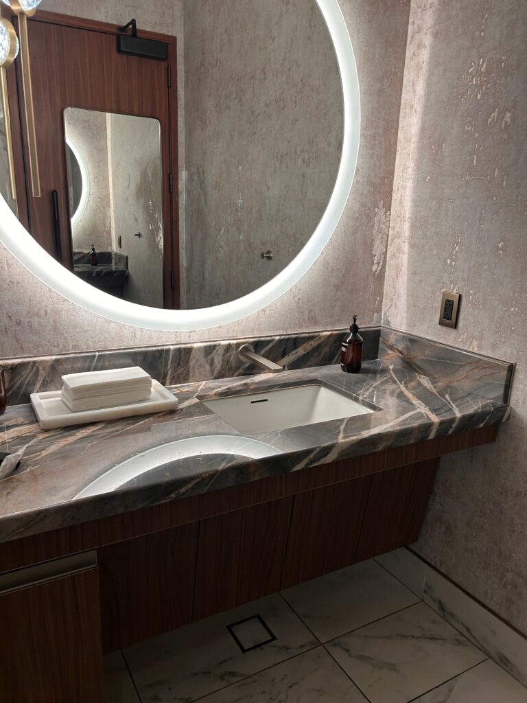 a bathroom with a round mirror