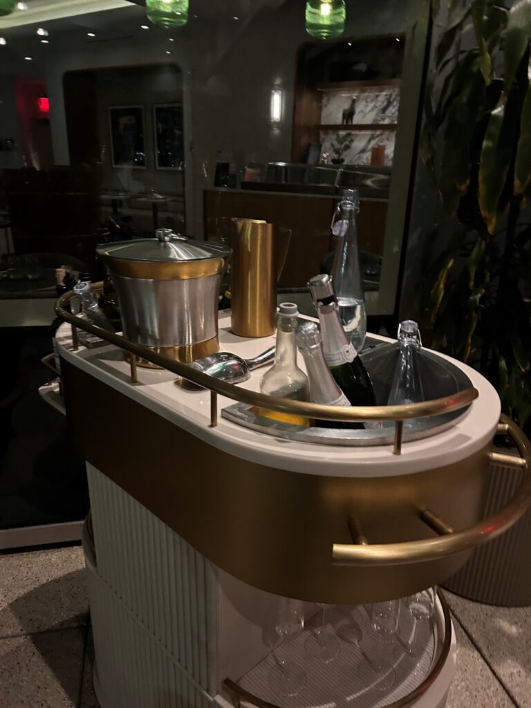 a bar cart with bottles and buckets