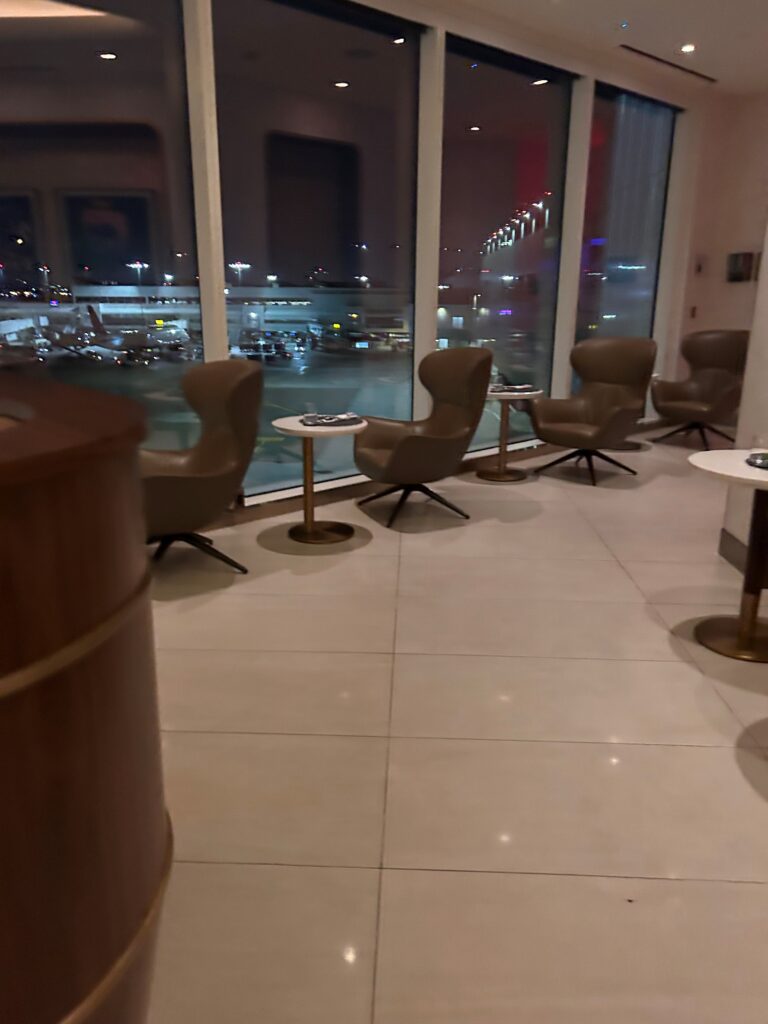 a room with chairs and tables and a window