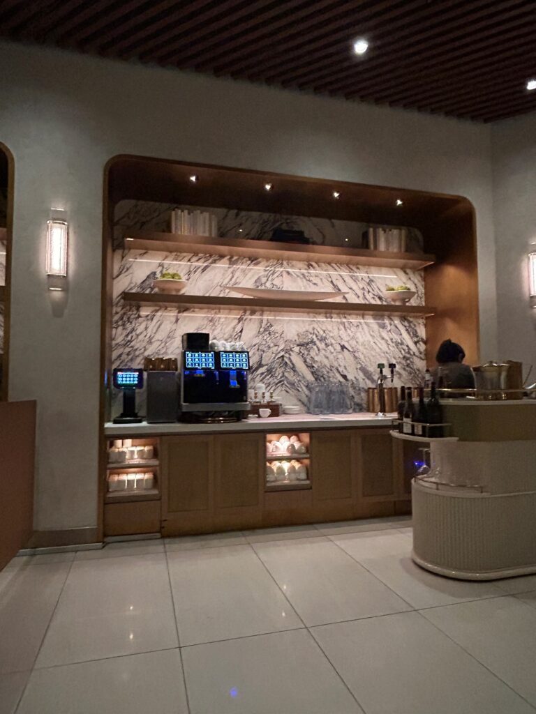a counter with a coffee machine and shelves