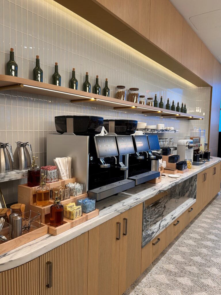 a coffee machine and bottles on shelves