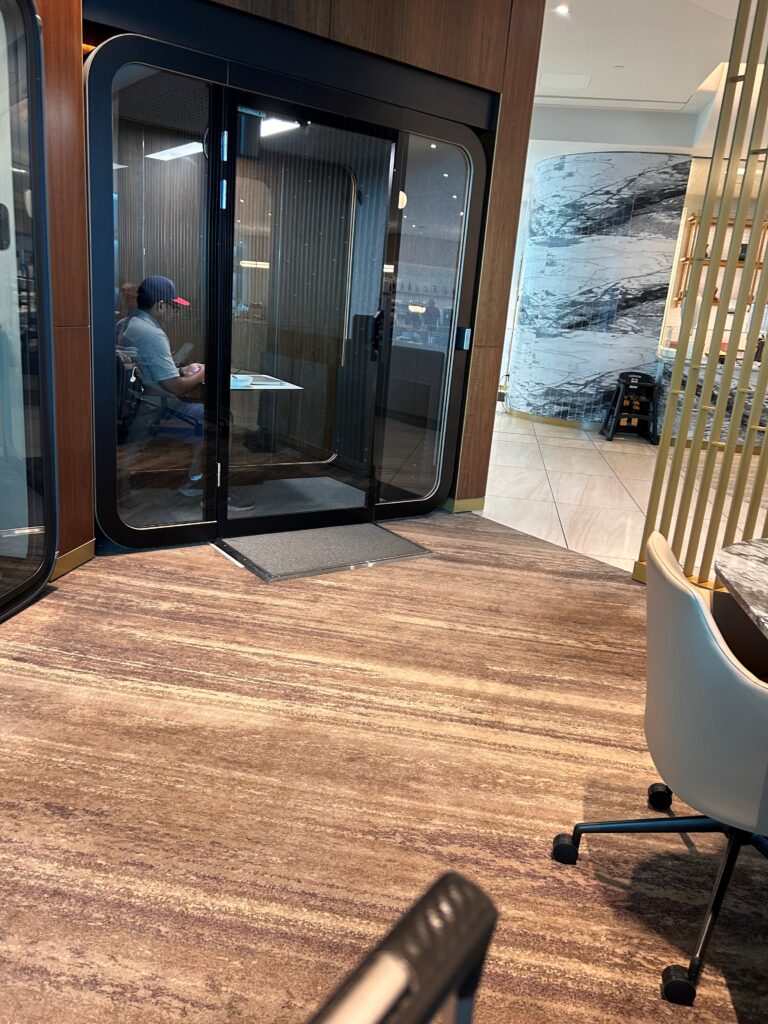 a man sitting in a chair in a room with glass doors