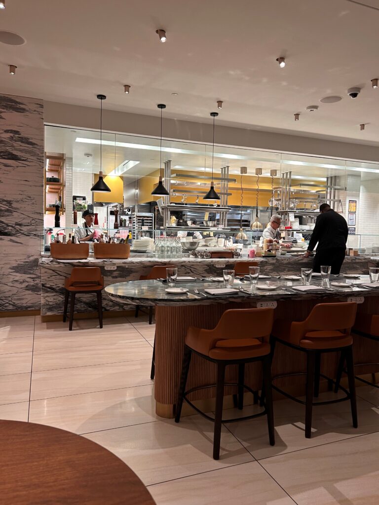 a restaurant with a chef behind the counter