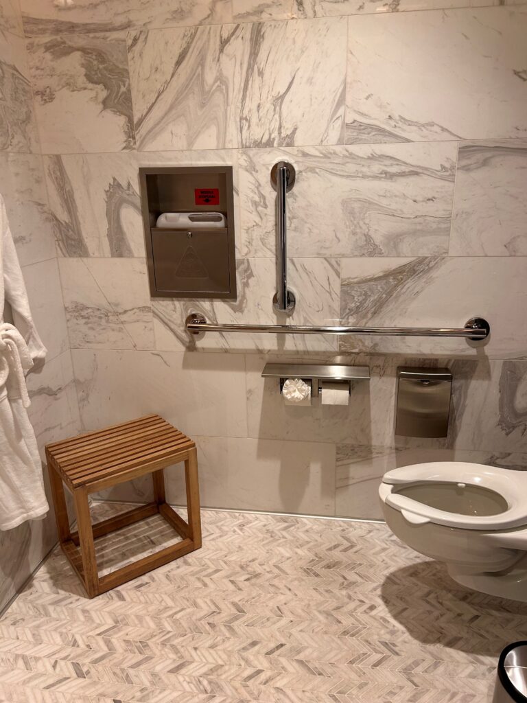 a bathroom with a toilet and a bar