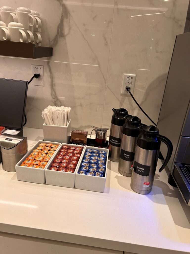 a coffee bar with a variety of condiments