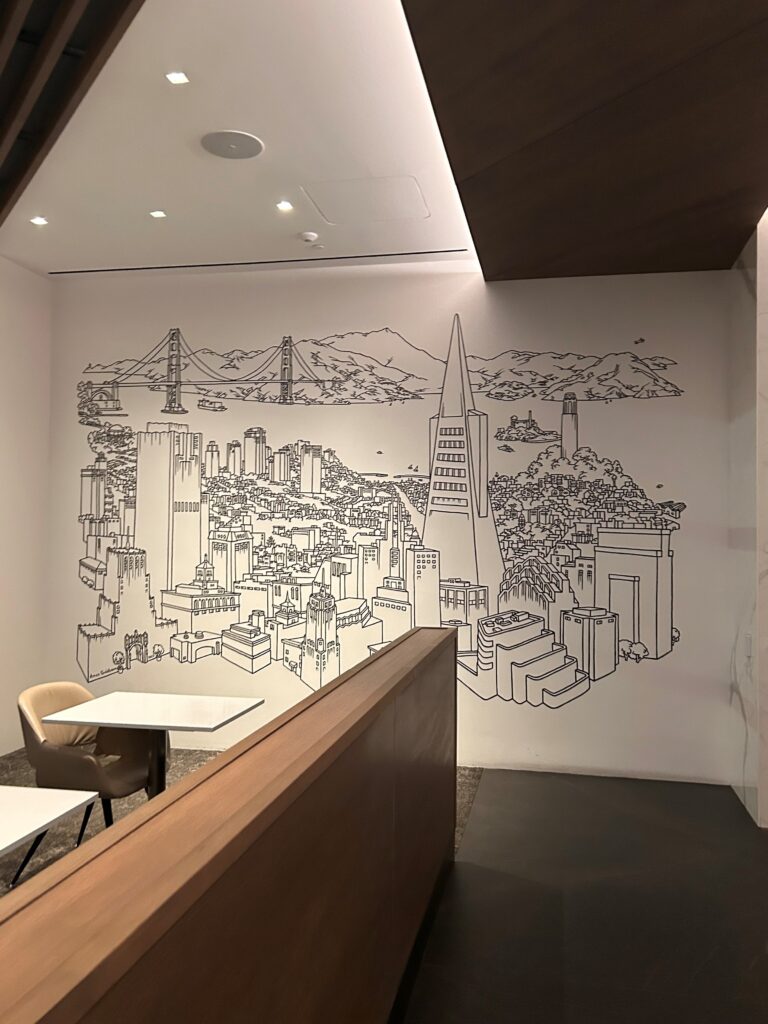 a wall with a drawing of a city and a bridge