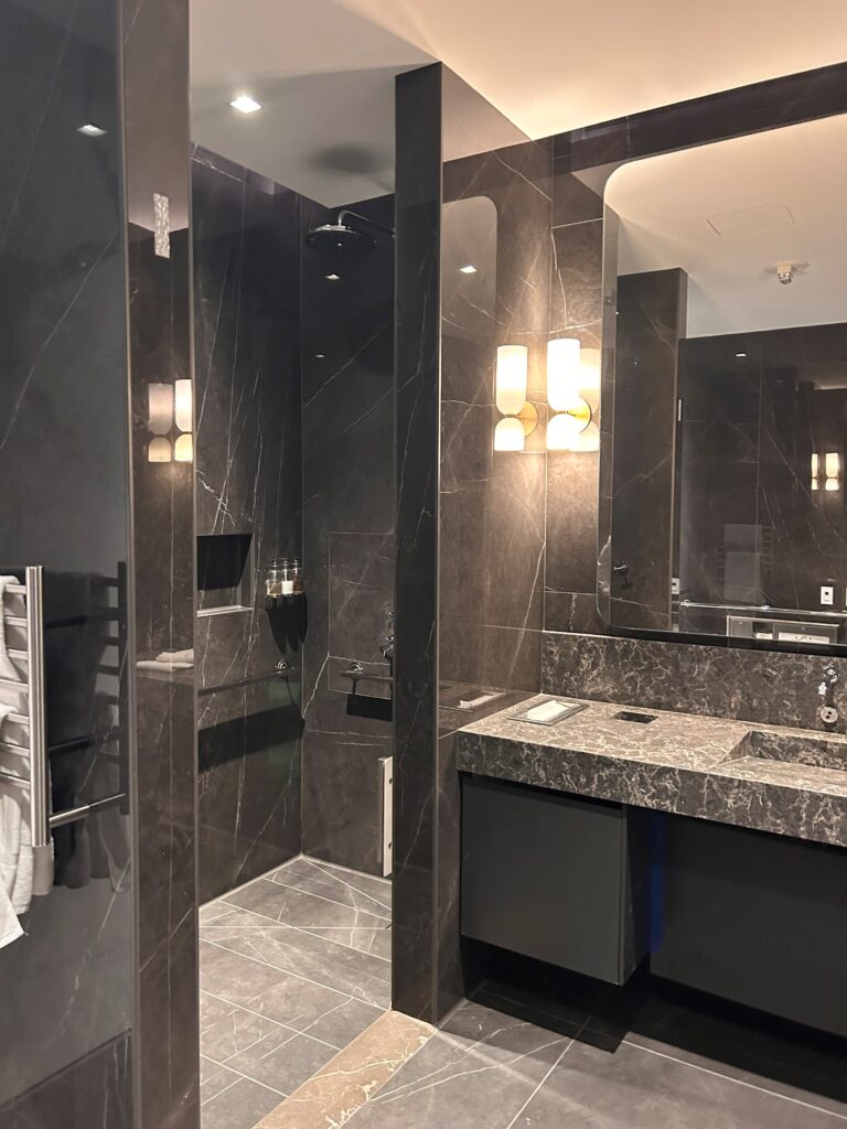 a bathroom with a marble shower and sink