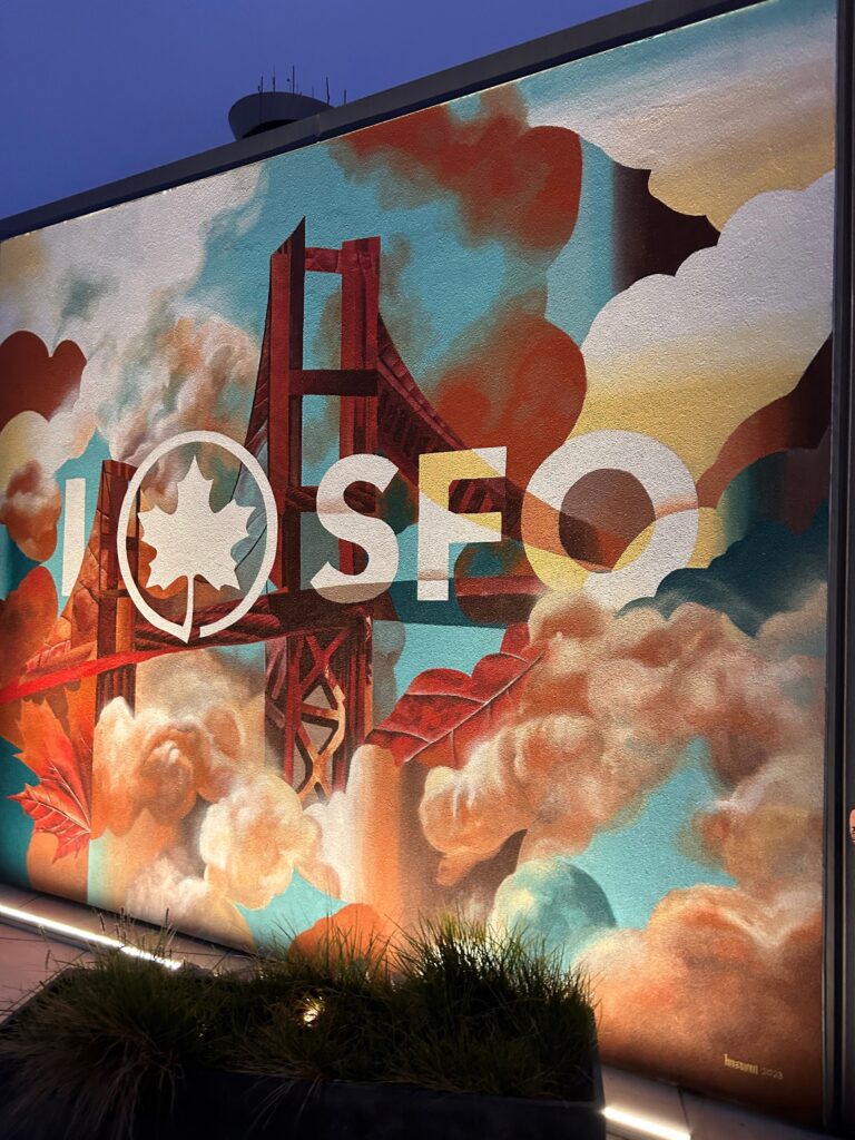 a mural of a bridge and clouds