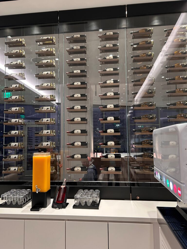a glass wall with bottles and glasses