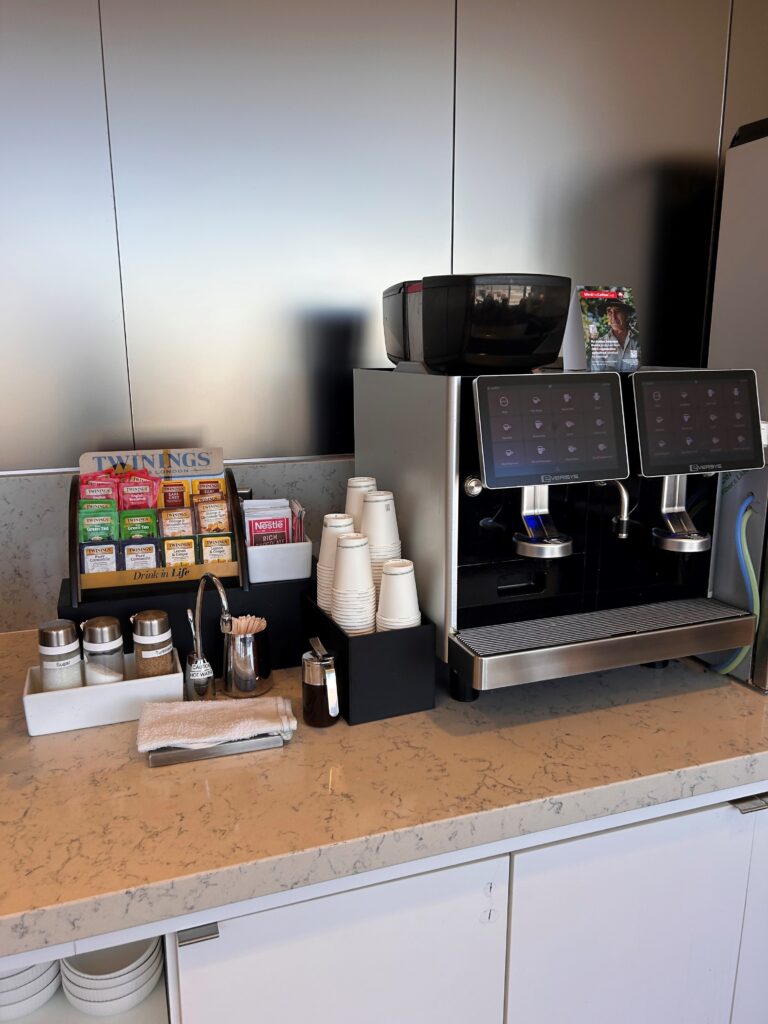 a coffee machine and condiments on a counter