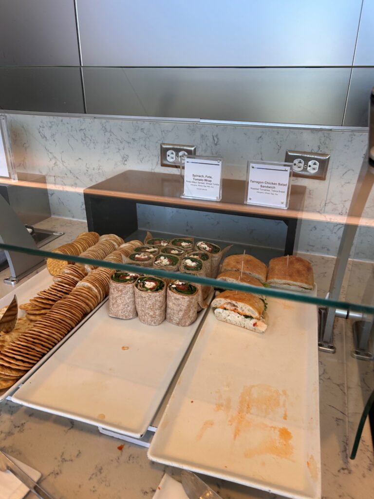 a display case with sandwiches and crackers