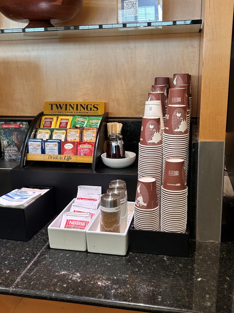 a stack of coffee cups and condiments