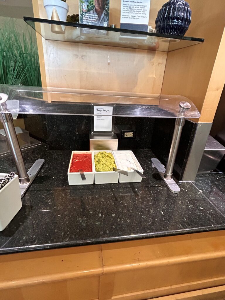a counter with containers of condiments on it