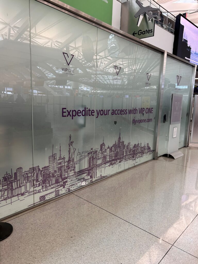 a glass wall with purple writing on it