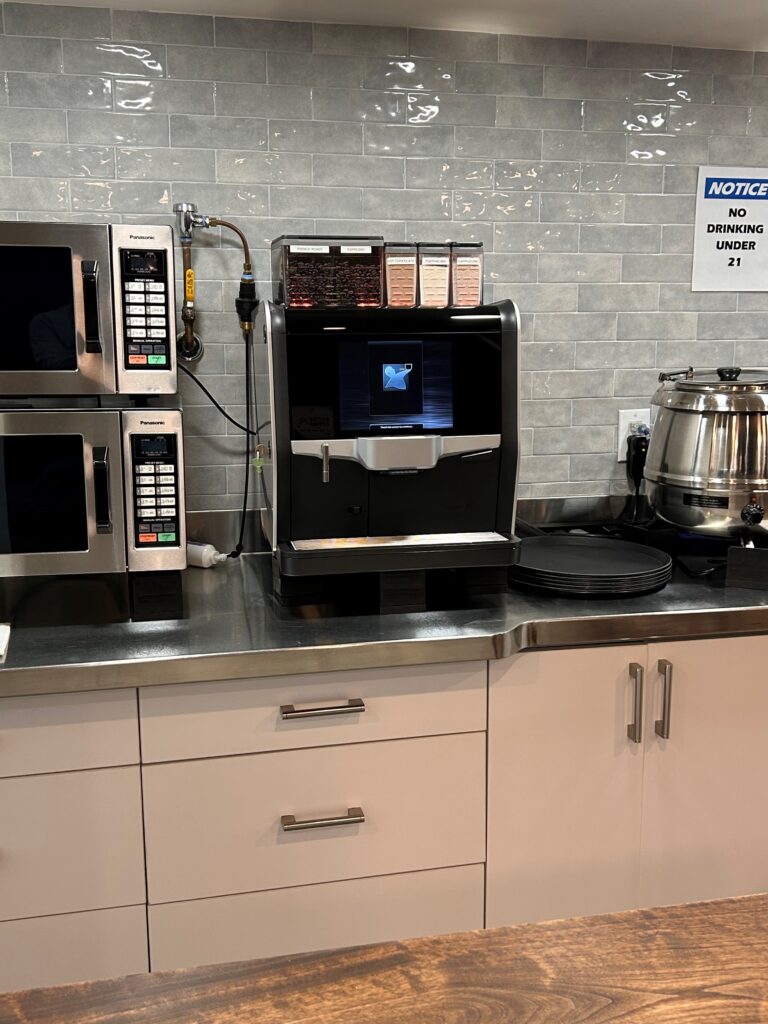 a kitchen with a microwave and coffee machine