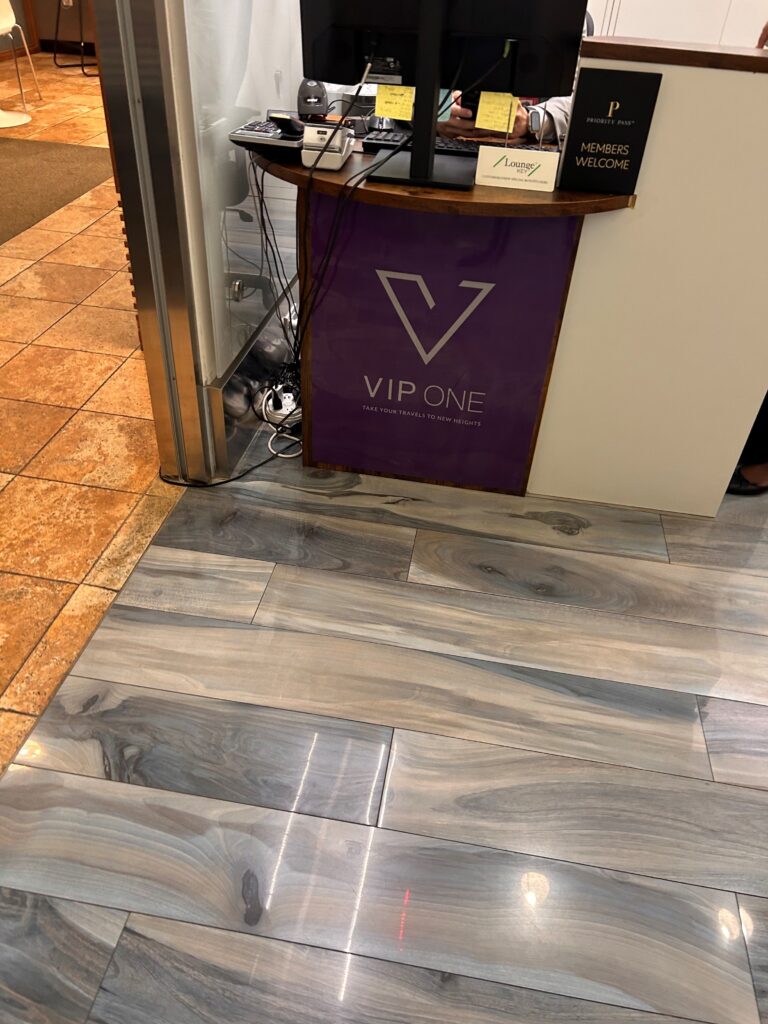 a counter with a purple sign and a silver door