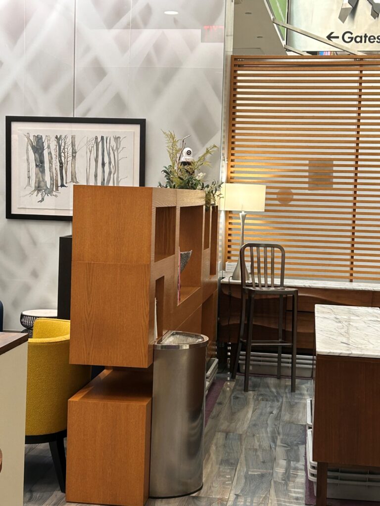 a room with a bookcase and a trash can