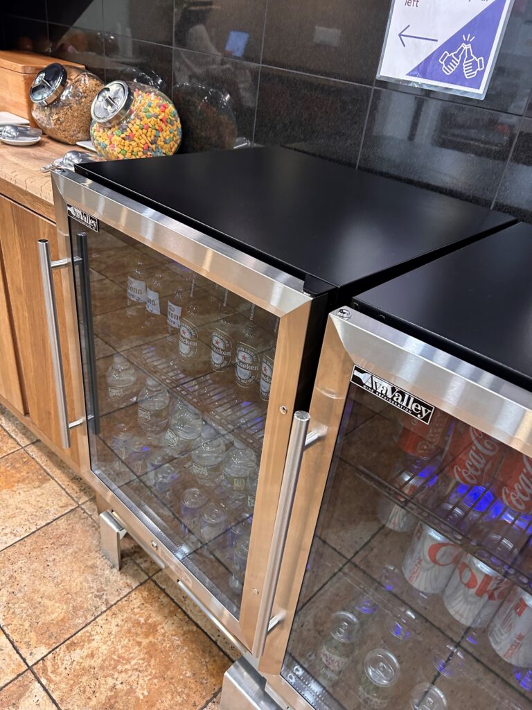 a refrigerator with glass doors and a black top