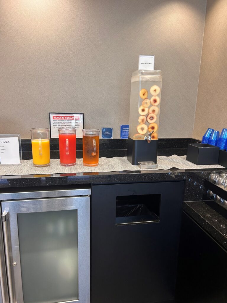 a beverage dispenser with donuts and orange juice