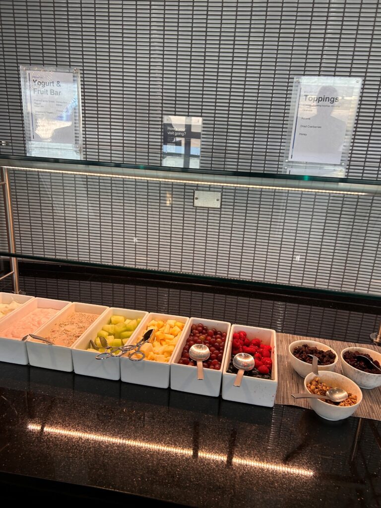 a row of bowls of fruit and cereals