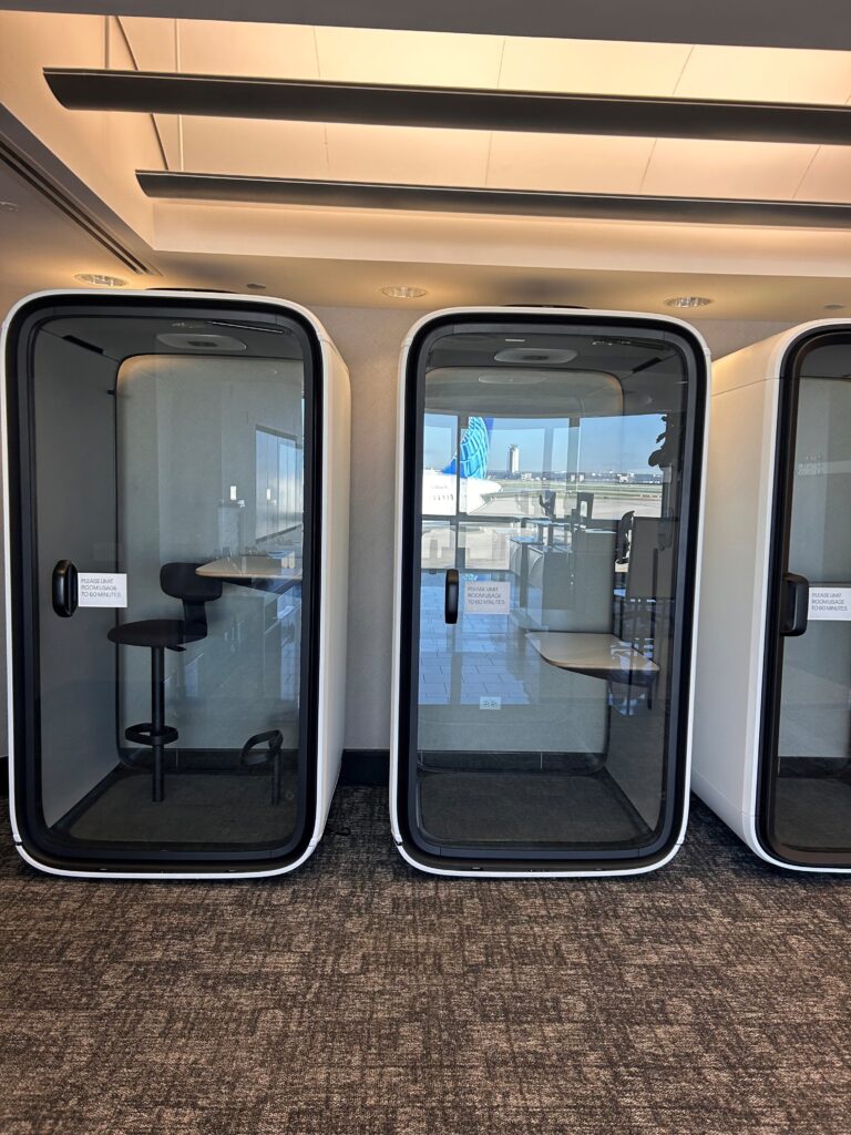 a group of white and black telephone booths