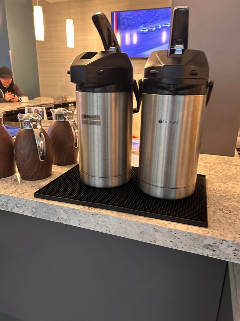 a couple of stainless steel containers on a counter
